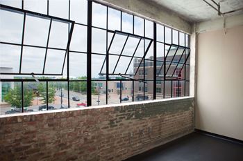 a view of the city from a window in an empty room